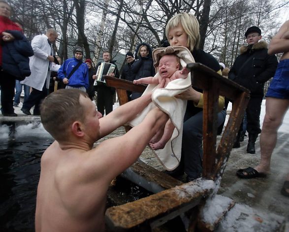  Russian parents Aleksander and Anna prepare to bathe their 2-month-old Viktor in icy water in St. Petersburg, where the air temperature was 27 degrees. Viktor obviously prefers hot baths. Photo: Dmitry Lovetsky, Associated Press